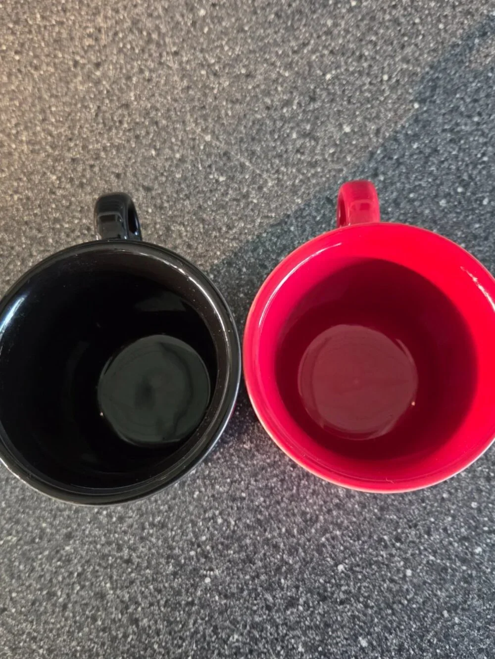 Fiestaware ceramic mugs in black and red with a ring handle, 10.25 oz capacity.